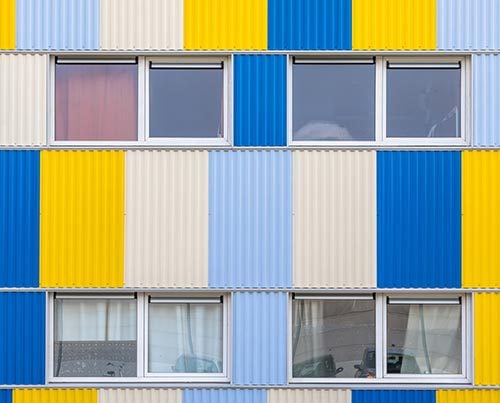Facade of a student residence in the color of blue, yellow and white