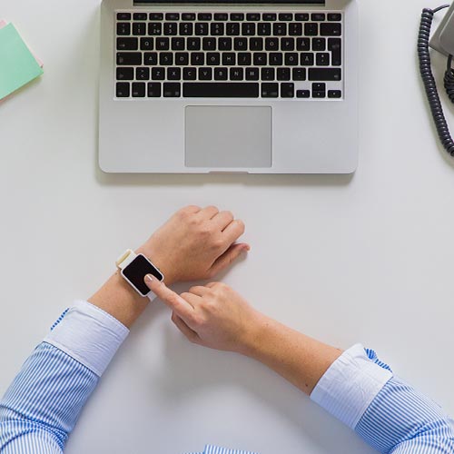 A sales manager uses a smartwatch for his time management